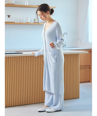 Woman wearing Gelato Pique USA's Thermal Smoothie Long Cardigan with ribbed texture, standing in a modern kitchen setting.