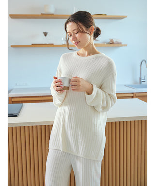 Woman wearing Thermal Smoothie Pullover Sweater, cozy and elegant loungewear by Gelato Pique USA, standing in a modern kitchen.