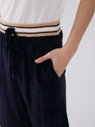 Person wearing Smooth Light Loungewear Shorts with sporty waistline and stylish embroidery in breathable fabric.