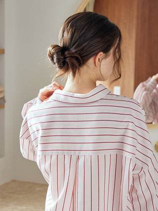 Back view of a woman wearing a striped long sleeve pajama shirt, showcasing its elegant design and comfortable fit.