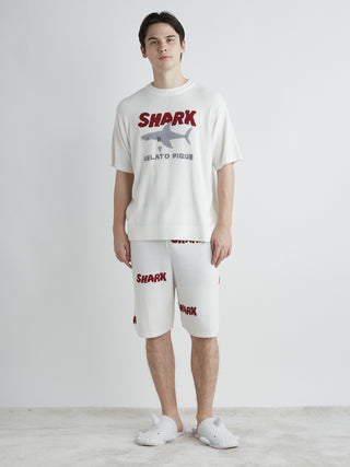 Model wearing COOL SHARK logo jacquard men's lounge shorts with shark print, offering comfort and style by Gelato Pique USA.