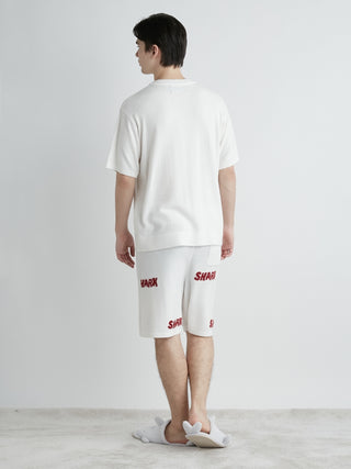 Man wearing COOL SHARK Logo Jacquard Men's Lounge Shorts by Gelato Pique USA, showcasing SHARK lettering and soft cooling fabric.