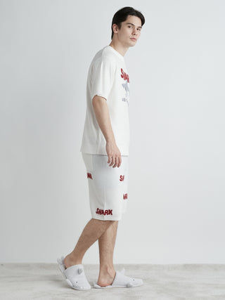 Model wearing COOL SHARK Logo Jacquard Men's Lounge Shorts with bold lettering and soft fabric, ideal for summer lounging comfort.