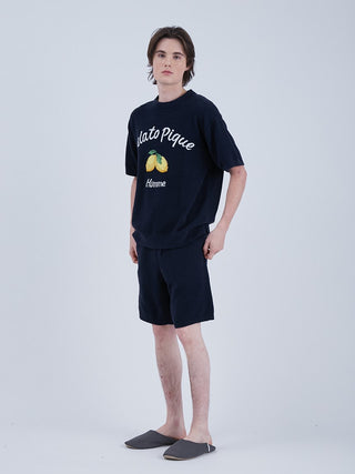 Model wearing Airmoco Ultra Comfy Men's Lounge Shorts with matching pullover, featuring a jacquard pattern of lemons and apricots.