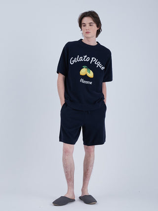 Model wearing ultra comfy Airmoco shorts and pullover with lemon design, showcasing stylish mens loungewear in navy blue.