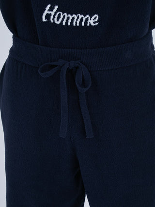 Close-up of Airmoco jacquard men's lounge shorts, featuring a drawstring waist and 'Homme' text detail on dark fabric.