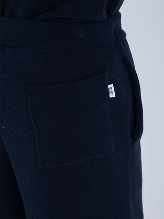 Close-up of navy Airmoco men's lounge shorts with pocket detail, highlighting the cozy jacquard fabric.