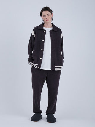 Model wearing Baby Moco Men's Long Lounge Pants and jacket, featuring Gelato Pique HOMME's exclusive 'Babymoco' material for warmth and style.