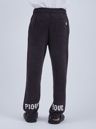 Rear view of Baby Moco Men's Long Lounge Pants in black with white Pique logo, made from luxurious 'Babymoco' material.