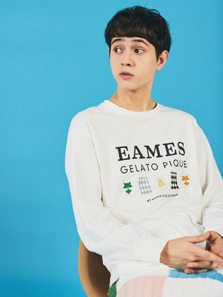 Man wearing EAMES House of Cards Men's Long Sleeve Tee with mid-century design, sitting against a blue background.