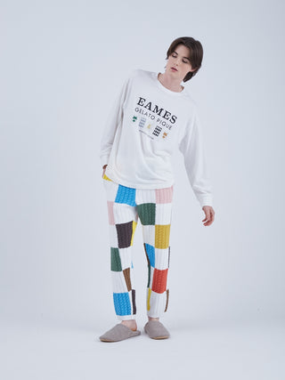 Model wearing EAMES House of Cards long sleeve tee with graphic print and patchwork pants, showcasing mid-century style.