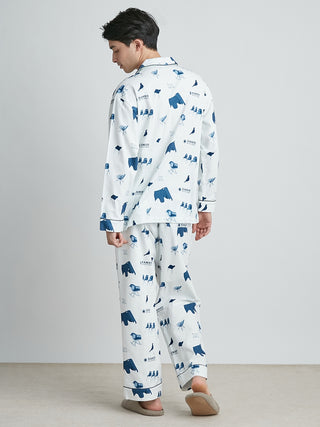 Man wearing EAMES Chair Motif Men's Pajama Shirt by GELATO PIQUE, showcasing mid-century style with blue piping and chair print design.