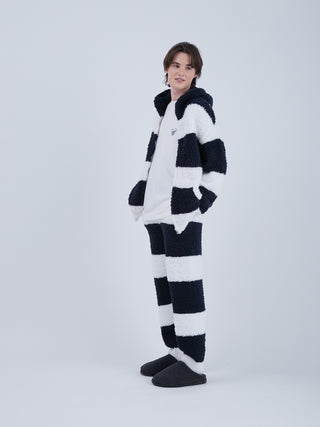 Model wearing navy and white striped fluffy pajama set, showcasing eco-friendly lounging pants and jacket ensemble.