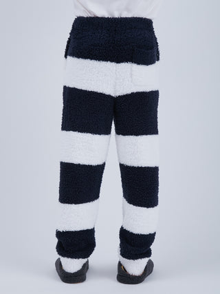 Back view of Sustainable Double Striped Men's Lounging Fluffy Pajama Pants, eco-friendly navy and white plush pants with ribbed hem and pockets.