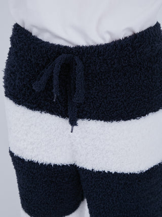 Close-up of navy and white striped fluffy pajama pants with drawstring, showcasing sustainable recycled gelato fabric.