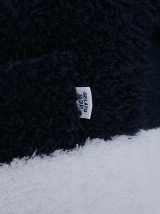 Close-up of fluffy gelato fabric tag on Sustainable Double Striped Men's Pajama Pants, highlighting eco-friendly texture.
