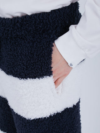 Close-up of navy and white striped fluffy pajama pants with pocket, made from recycled fabric for eco-friendly comfort and style.