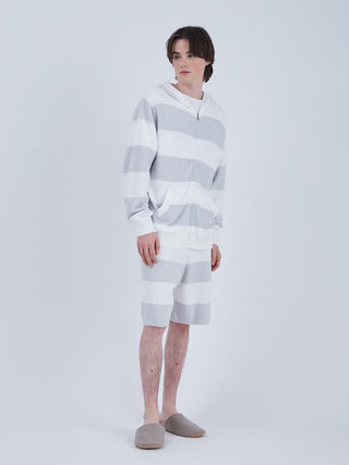 Man wearing Men's Smoothie 2 Stripe Lounge Shorts and matching hoodie, showcasing a comfortable and stylish spring outfit.