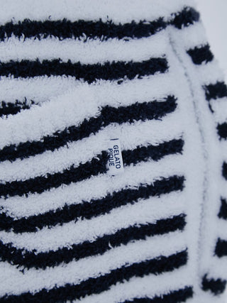 Close-up of Baby Moco Duck Stripe fabric with Gelato Pique label, showcasing plush black and white stripes for men’s lounge pants.