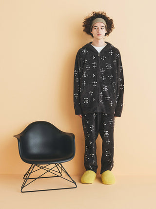 EAMES Mens Jacquard Fluffy Long Pants by Gelato Pique with dot pattern, sustainable luxury room wear, model standing beside Eames chair