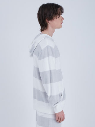Side view of a person wearing a mens striped zip-up hoodie with vibrant colors, showcasing the unique border pattern and comfortable fit.