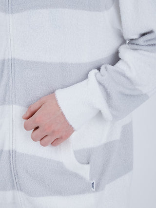 Close-up of a gray and white striped zip-up hoodie showing sleeve and pocket detail, highlighting soft fabric texture.