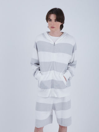 Man wearing Mens Smoothie 2 Striped Zip Up Hoodie with vibrant stripes, featuring a cozy and stylish design, ideal for casual outings.