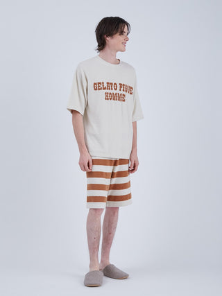 Man wearing Smoothie Logo Mens Shorts and Top Loungewear Set with beige and brown stripes, showcasing casual comfort for summer days.