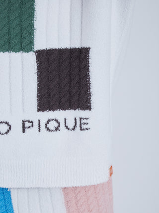 Close-up of EAMES Air Moco Logo Men's Knit Pullover with colorful geometric design and logo on white fabric.