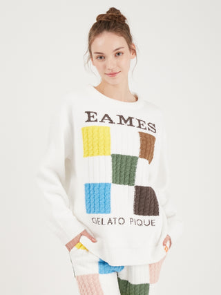 Model wearing Gelato Pique EAMES Air Moco Check-Logo Long Sleeve Pullover Sweater with colorful checkered pattern.
