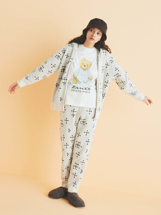 Woman wearing EAMES Smoothie zip-up hoodie with dot pattern, complemented by matching loungewear pants, set against a cream backdrop.