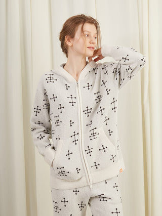 Woman wearing EAMES Smoothie zip-up hoodie with dot pattern, showcasing mid-century inspired design for cozy loungewear.