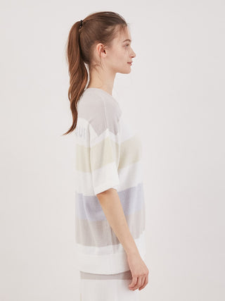 Woman wearing Smoothie Family Border Short-Sleeved Pullover in pastel stripes, showcasing cozy chic loungewear style from the side view.