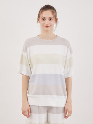 Woman wearing Smoothie Family Border Short-Sleeved Pullover in pastel stripes, perfect for cozy and chic loungewear style by Gelato Pique.