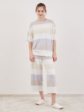 Woman wearing Smoothie Family Border Short-Sleeved Pullover with pastel stripes for cozy loungewear style.