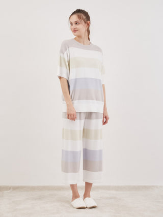 Model wearing Smoothie Family Border Short-Sleeved Pullover with pastel stripes, showcasing cozy and chic loungewear.