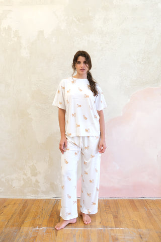 Woman wearing white Shiba Motif Lounge T-shirt and pants by Gelato Pique USA, featuring hand-drawn Shiba Inu print, premium loungewear.