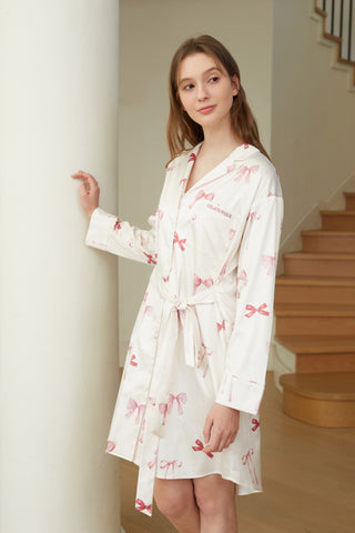 Woman wearing a Ribbon Pattern Satin Shirt Dress with bow print, showcasing elegant loungewear fashion.