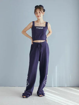 Woman wearing Airy Moco Flower Logo Jacquard Cropped Tank Top and matching pants, in deep navy color by Gelato Pique, chic loungewear set.