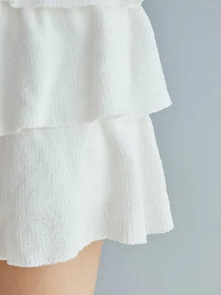 Close-up of white Airy Moco tiered mini skirt from Gelato Pique, highlighting its soft, lightweight fabric and elegant tiers.