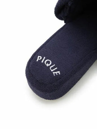 Close-up of black Airy Moco Tiered House Slippers by Gelato Pique, featuring plush texture and white logo stitching.