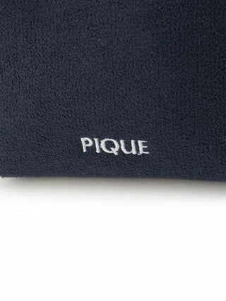 Close-up of Gelato Pique logo on deep navy Airy Moco Flower Pouch fabric, showcasing plush texture.