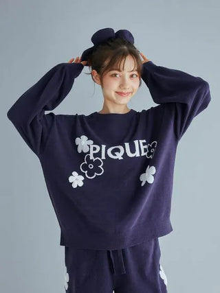 Model wearing Airy Moco Flower Logo Jacquard Pullover Sweater by Gelato Pique, navy with white floral design, cozy and stylish lounge wear.