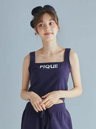 Woman wearing Airy Moco Flower Logo Jacquard Cropped Tank Top in deep navy by Gelato Pique, showcasing chic and comfortable style.