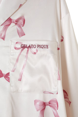 Close-up of Ribbon Pattern Satin Shirt Dress with pink bow design and Gelato Pique logo on the pocket.