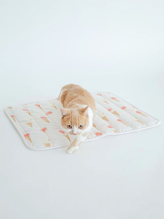 Cat lounging on CAT&DOG Ice Cream Motif Cooling Mat with colorful ice cream cone print for pets by GELATO PIQUE USA.