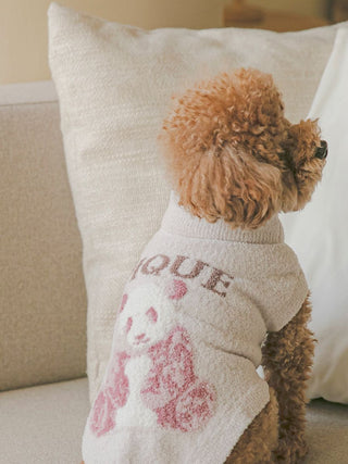 Dog wearing CAT&DOG panda jacquard high-neck pet clothes, sitting on a sofa.