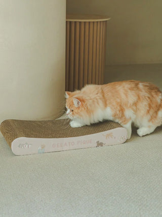 Cat pattern scratching board by Gelato Pique with a playful cat on a beige carpet.