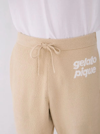 Close-up of Mens Air Moco Logo Jacquard Lounge Pants by Gelato Pique, featuring an adjustable drawstring and logo detail on beige fabric.