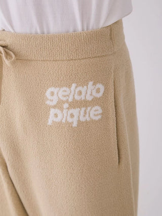 Close-up of beige Gelato Pique Air Moco Lounge Pants with logo, featuring a drawstring waist and jacquard texture.